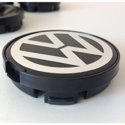 Single 55mm Volkswagen wheel centre cap close-up with VW logo